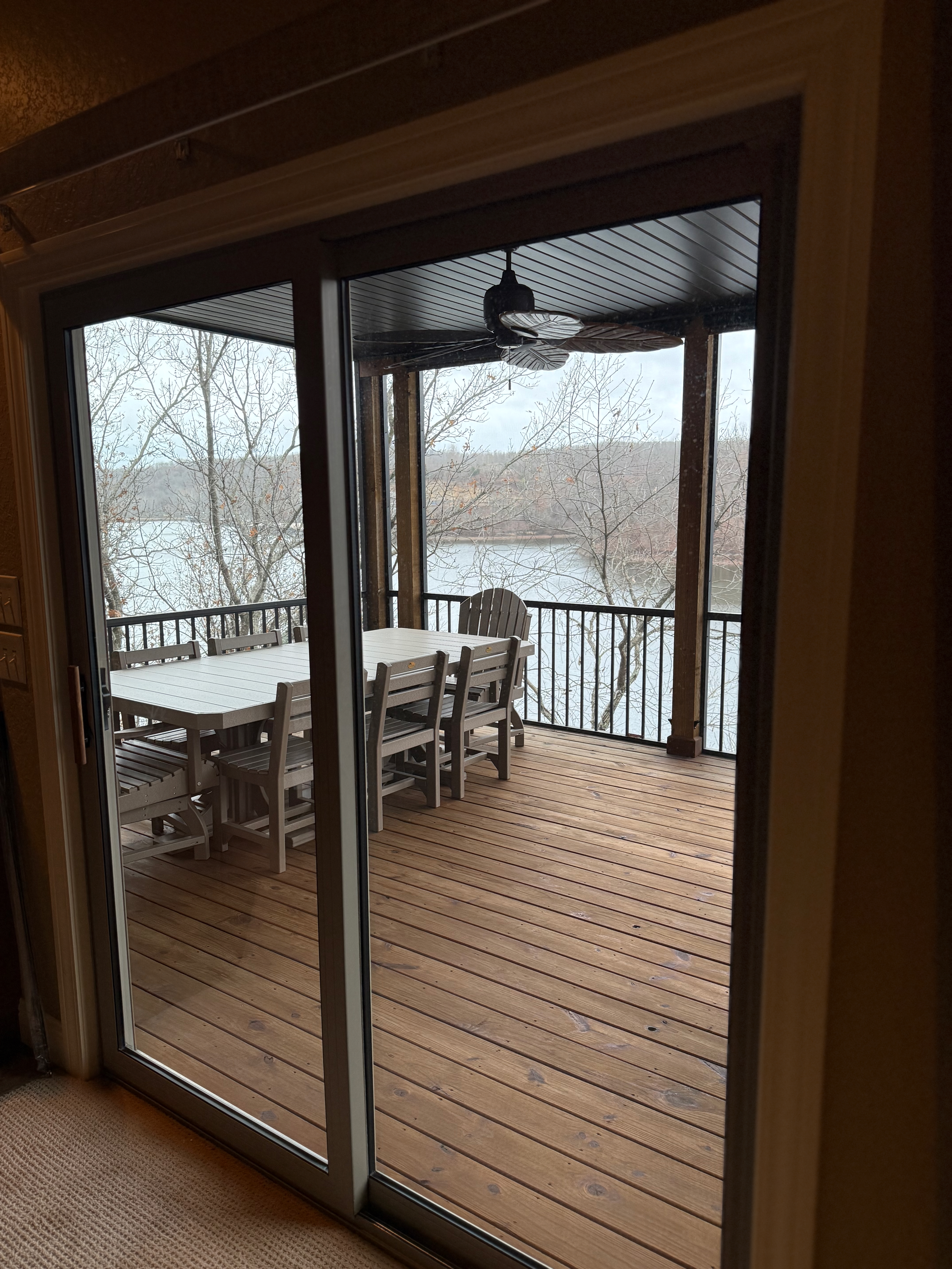 Covered deck with dining table and lake view