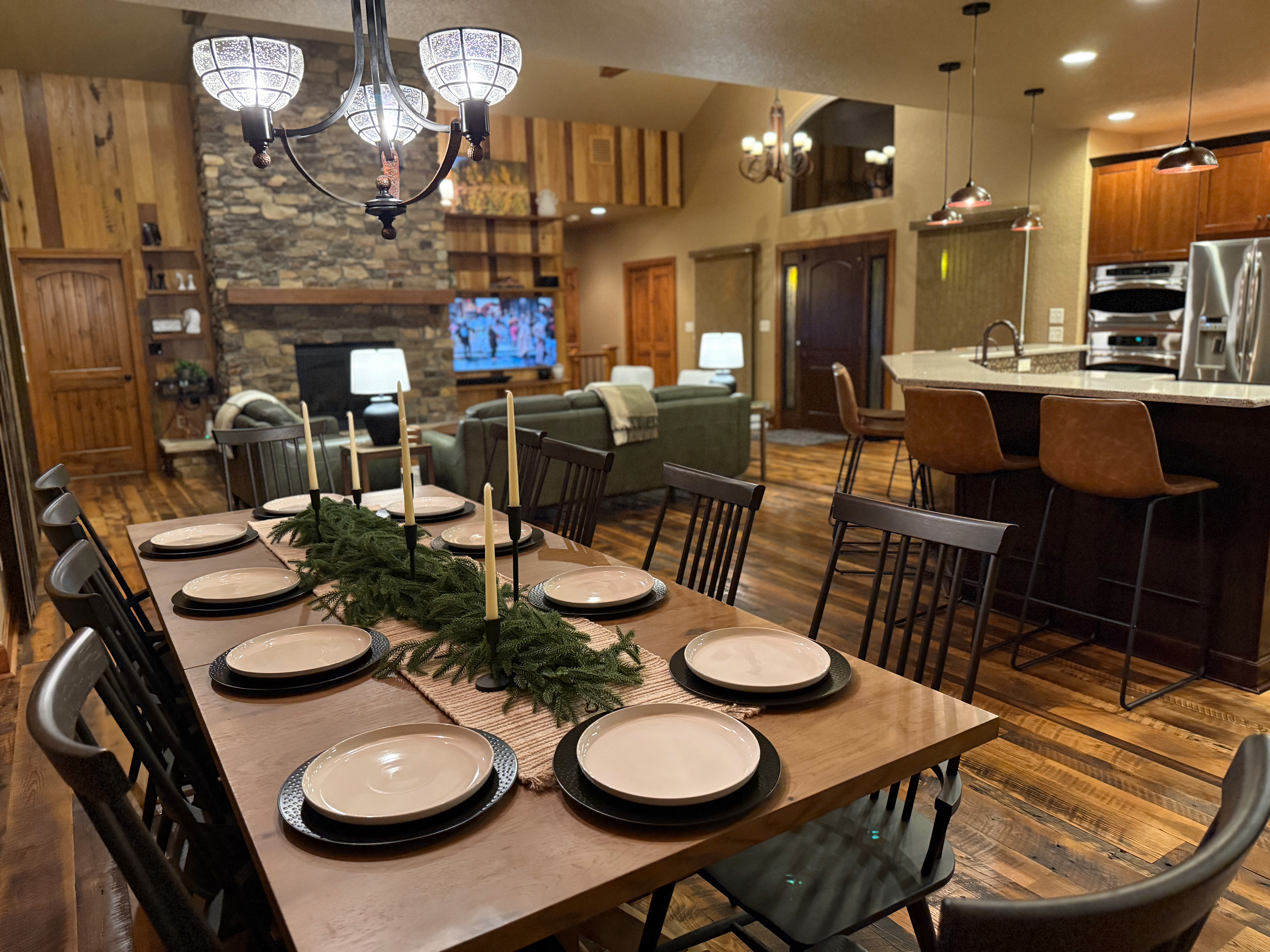 Dining table set for 10 with stone fireplace and barnwood accents
