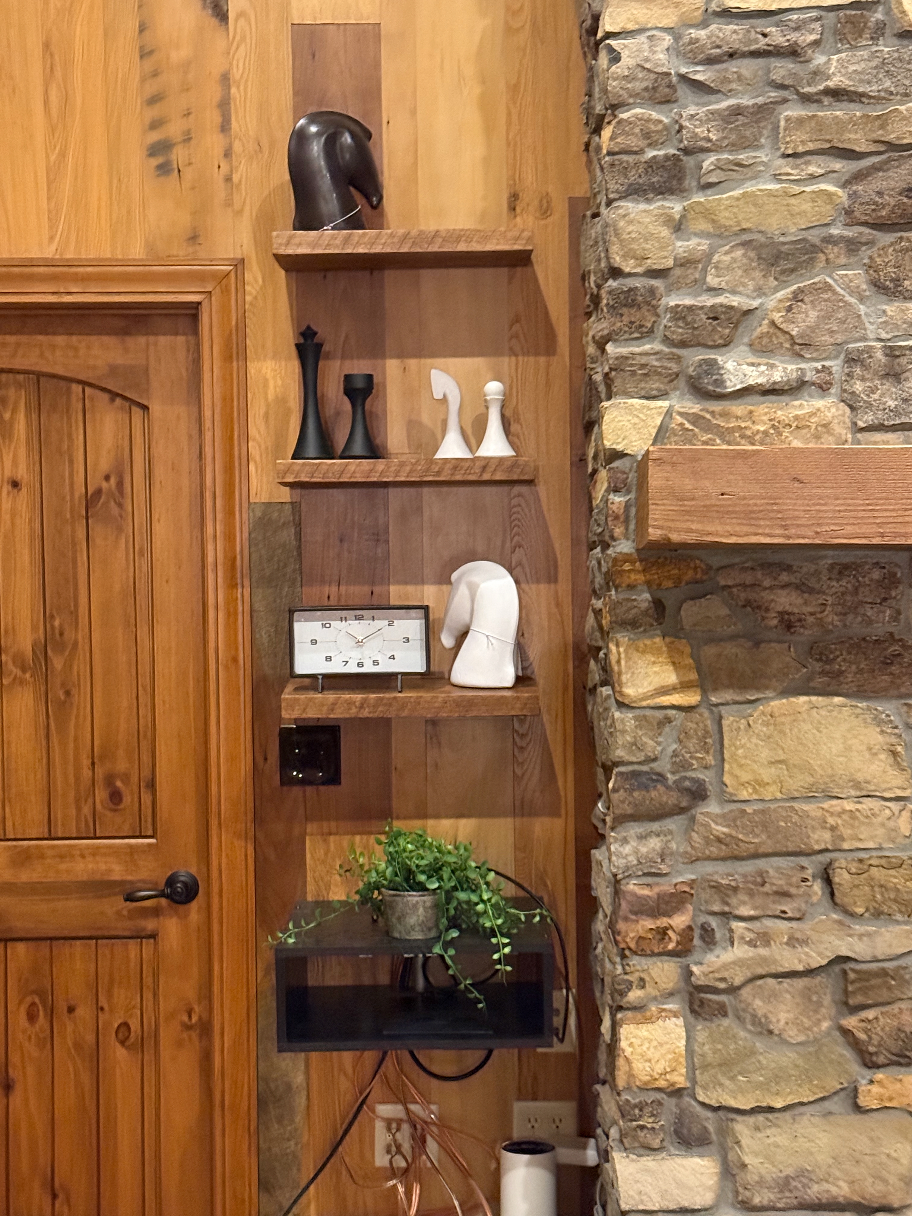 Barnwood shelving and stone fireplace detail